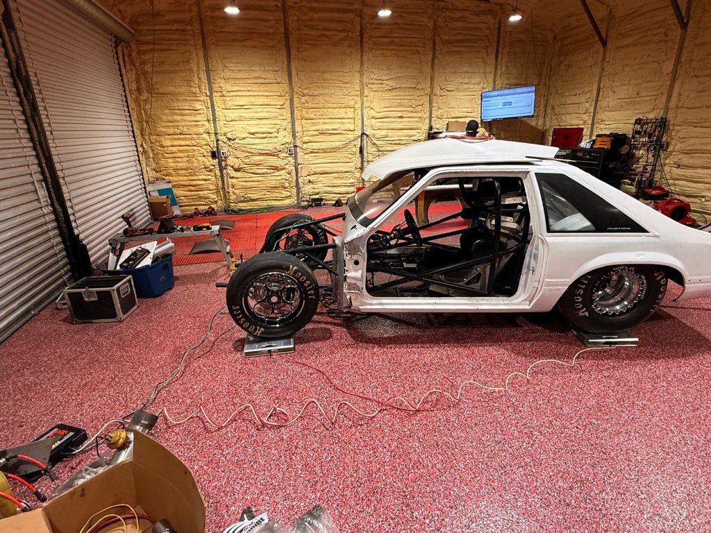 Caged Mustang race car in the shop